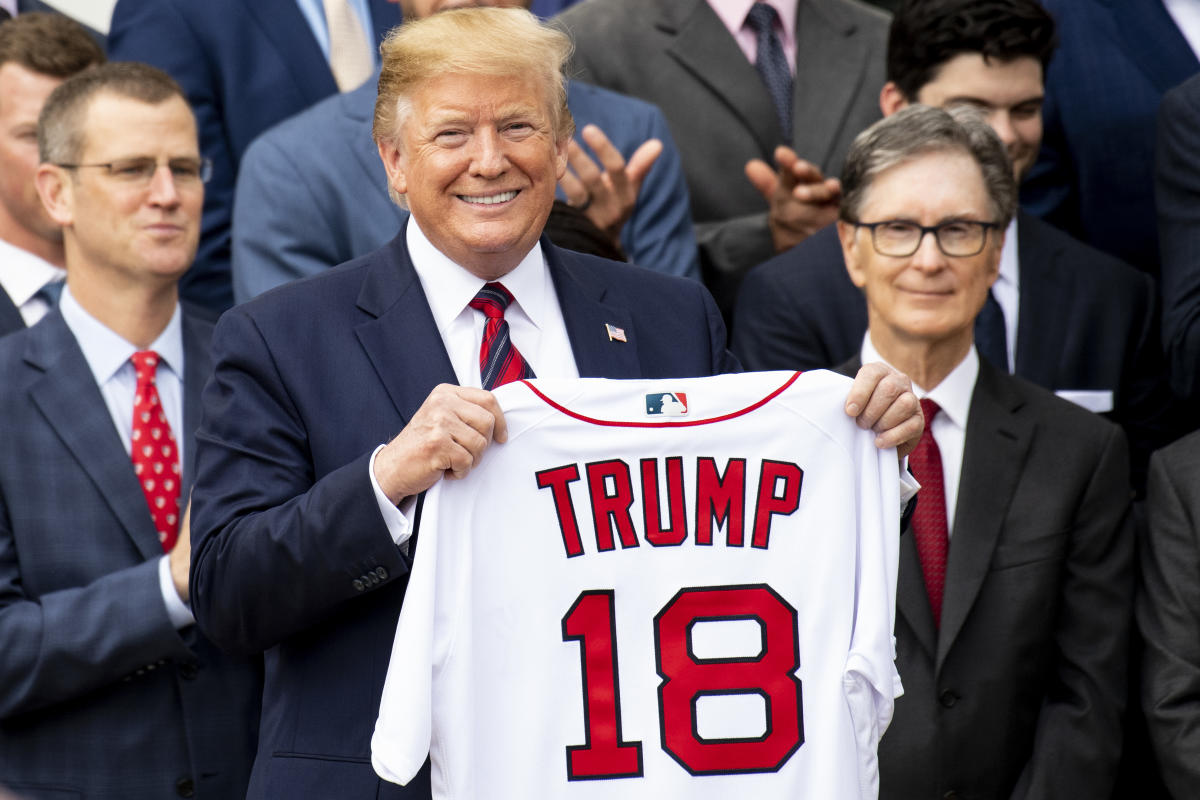 President Donald Trump is presented with a Boston Red Sox baseball team  jersey by Red Sox outfielder J. D. Martinez, during a ceremony on the South  Lawn of the White House in