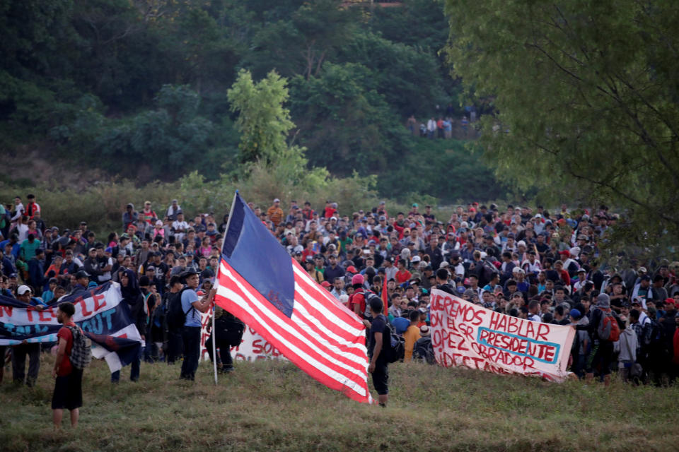 Migrants, mainly from Central America, marching in a caravan walk after crossing the Suchiate river on the outskirts of Ciudad Hidalgo