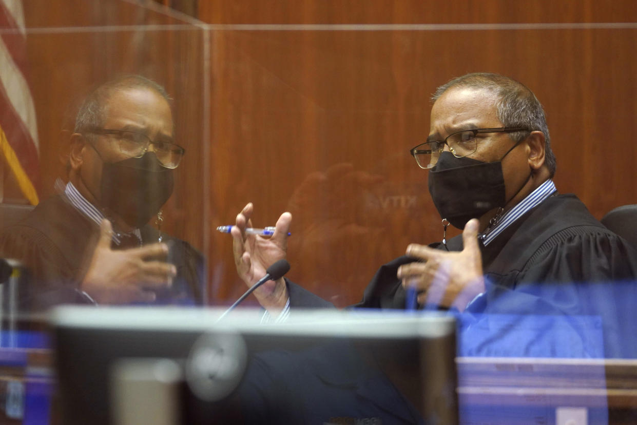 Judge William Domingo gestures during the final day of preliminary hearings for three Honolulu police officers accused in the fatal shooting of a teenager, at district court Wednesday, Aug. 18, 2021, in Honolulu. Domingo rejected murder and attempted murder charges against the officers, preventing the case from going to trial. (Cory Lum/Honolulu Civil Beat via AP, Pool)