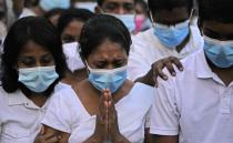 Nilushi, wife of Sri Lankan factory manager Priyantha Kumara who was lynched by a Muslim mob in Pakistan for alleged blasphemy grieves during his burial in Colombo, Sri Lanka, Wednesday, Dec. 8, 2021. (AP Photo/Eranga Jayawardena)