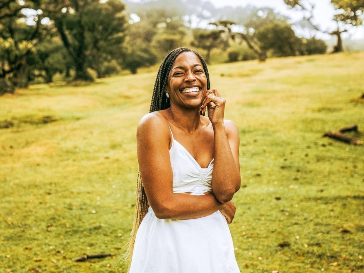 Monet Hambrick wearing a white dress and smiling in Madeira, Portugal.