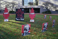 Posters stand on the south lawn Tuesday, Nov. 30, 2021, at the Hennepin County Government Center in Minneapolis where jury selection begins for former suburban Minneapolis police officer Kim Potter, who says she meant to grab her Taser instead of her handgun when she shot and killed motorist Daunte Wright. (AP Photo/Jim Mone)