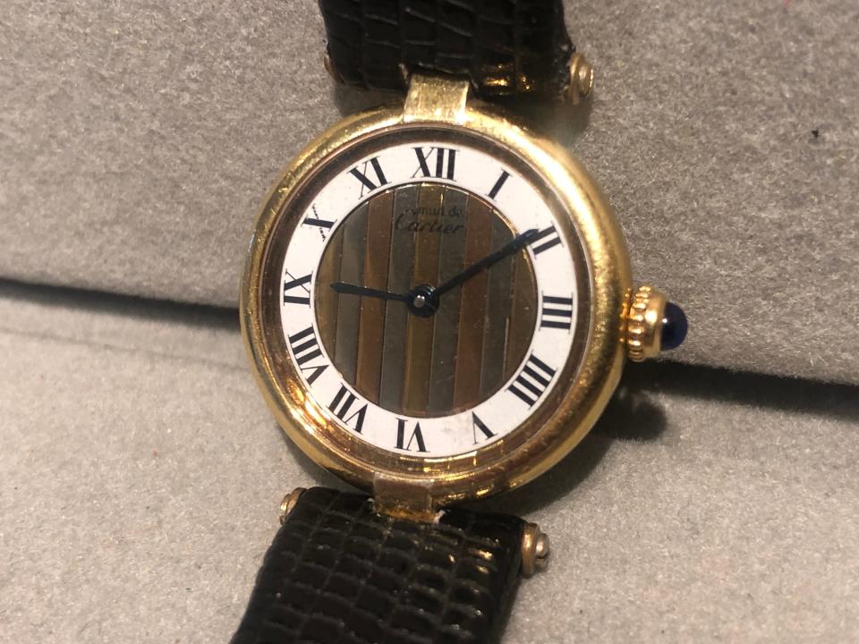 This vintage Pasha model by Cartier ($990) includes a gold over sterling case and sapphire-topped crown.