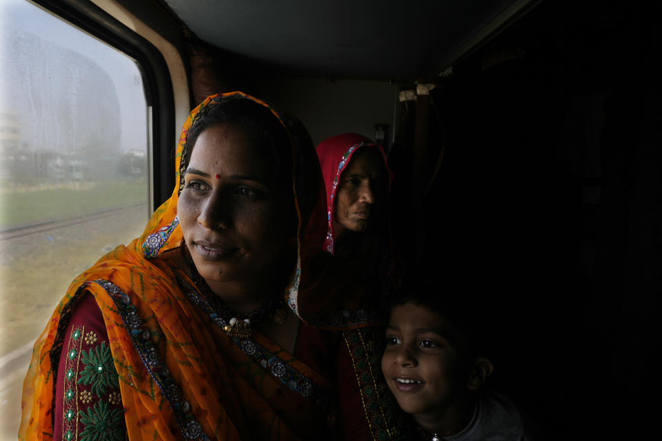 Samodhra Meena, left, from the northern Indian state of Rajasthan travels with her mother-in-law and son, in the Thirukkural Express, India, Sunday, April 21, 2024. (AP Photo/Manish Swarup)
