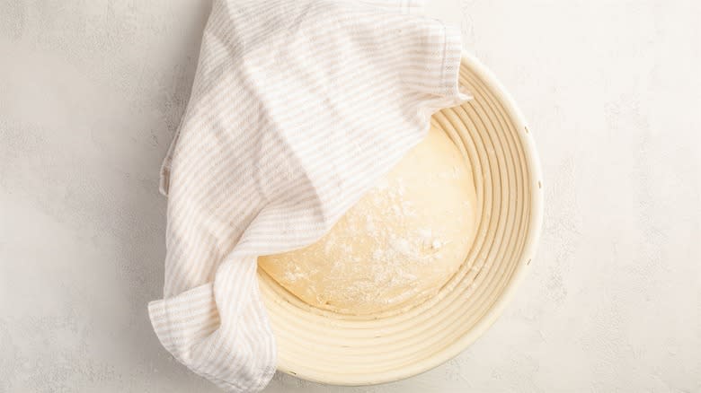 Dough resting in cloth-covered bowl