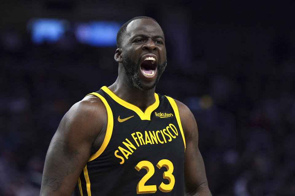 Golden State Warriors forward Draymond Green (23) tries to get the crowd pumped up during the first half of an NBA basketball game against the Cleveland Cavaliers on Saturday, Nov. 11, 2023, in San Francisco. (AP Photo/Loren Elliott)
