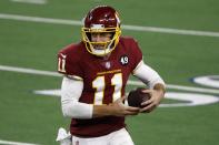 Washington Football Team quarterback Alex Smith (11) runs the ball in the second half of an NFL football game against the Dallas Cowboys in Arlington, Texas, Thursday, Nov. 26, 2020. (AP Photo/Roger Steinman)