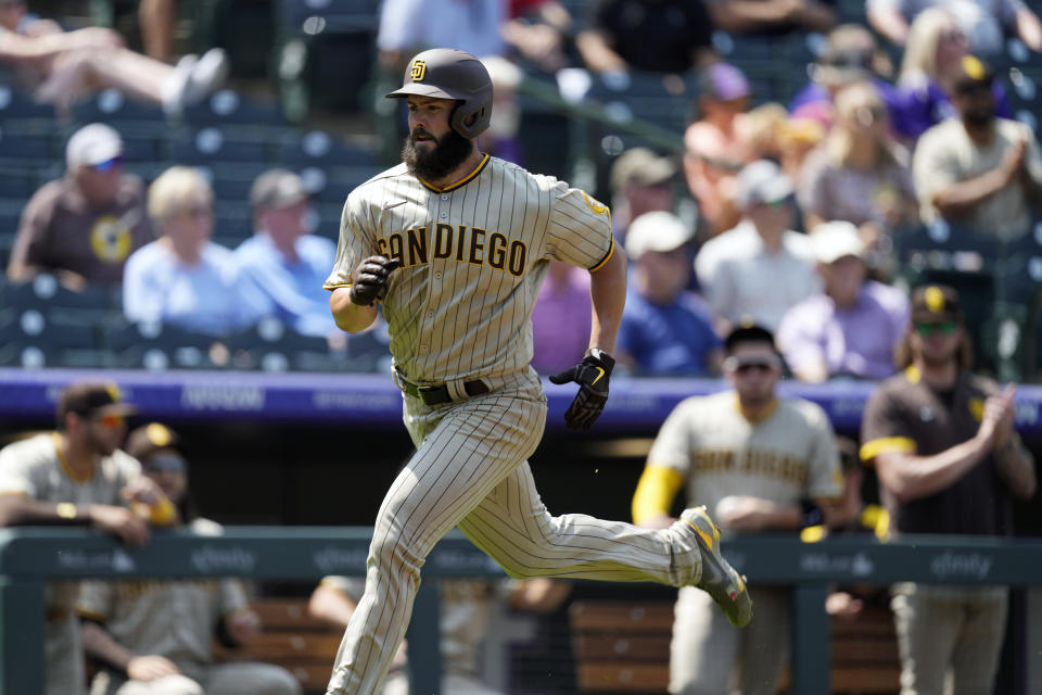 San Diego Padres' Jake Arrieta rounds third base to score on a single hit by Manny Machado off Colorado Rockies starting pitcher Chi Chi Gonzalez in the third inning of a baseball game Wednesday, Aug. 18, 2021, in Denver. (AP Photo/David Zalubowski)