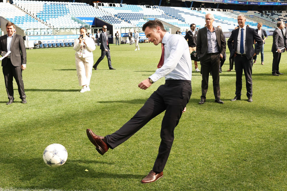 SYDNEY, AUSTRALIA - OCTOBER 18: NSW Premier Chris Minns kicks a balll at the announcement of the Unite round when all A leagues games will be played in Sydney during an A-Leagues Media Opportunity at Allianz Stadium on October 18, 2023 in Sydney, Australia. (Photo by Mark Evans/Getty Images for APL)