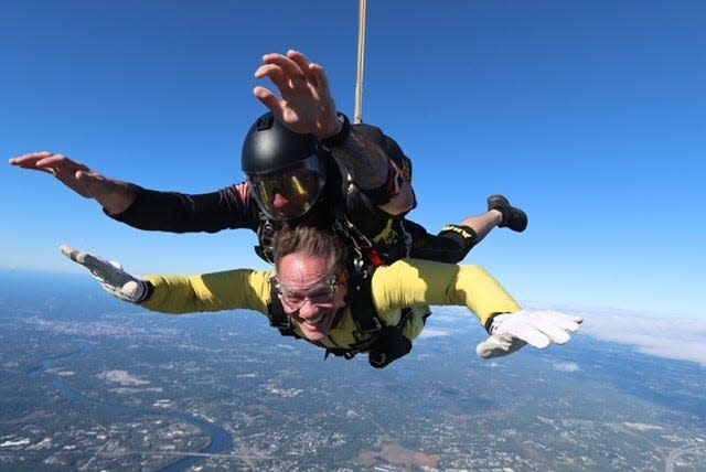 Commissioner Frank Edelblut of the New Hampshire Department of Education tandem jumps with a member of the Golden Knights, the U.S. Army’s Parachute Team, on Wednesday at the Lawrence Municipal Airport.