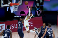 Dallas Mavericks' Antonius Cleveland (3) fouls Utah Jazz's Rayjon Tucker during the first half of an NBA basketball game Monday, Aug. 10, 2020, in Lake Buena Vista, Fla. (AP Photo/Ashley Landis, Pool)