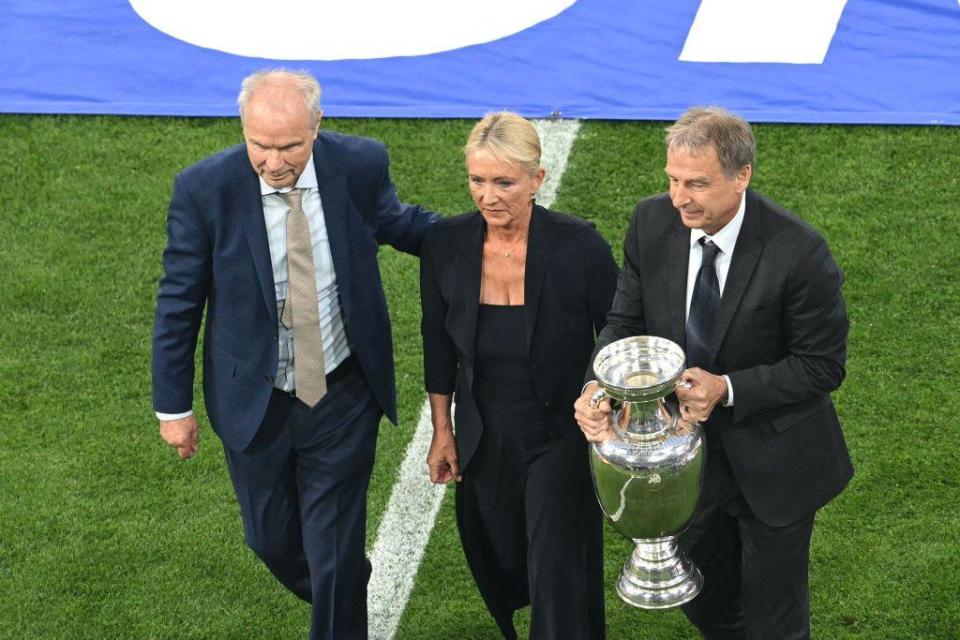 Bernard Dietz and Jurgen Klinsmann, alongside Franz Beckenbauer's widow Heidi, bring the European Championship trophy