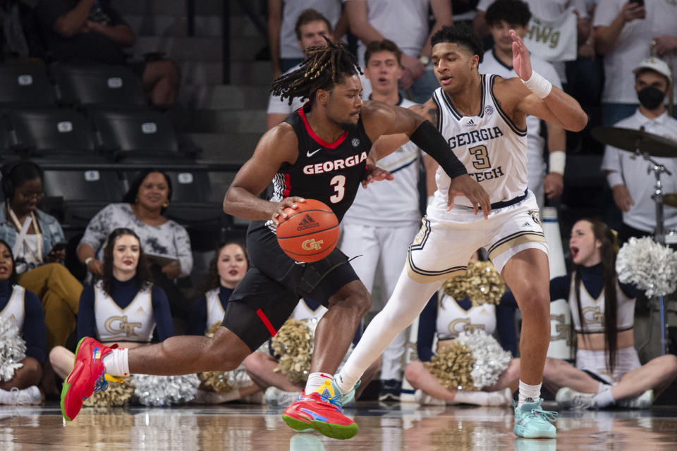 Georgia guard Kario Oquendo drives against Georgia Tech guard Dallan Coleman during the second half of an NCAA college basketball game Tuesday, Dec. 6, 2022, in Atlanta. (AP Photo/Hakim Wright Sr.)