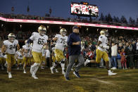 Notre Dame coach Brian Kelly, center, runs onto the field for the team's NCAA college football game against Stanford in Stanford, Calif., Saturday, Nov. 27, 2021. (AP Photo/Jed Jacobsohn)