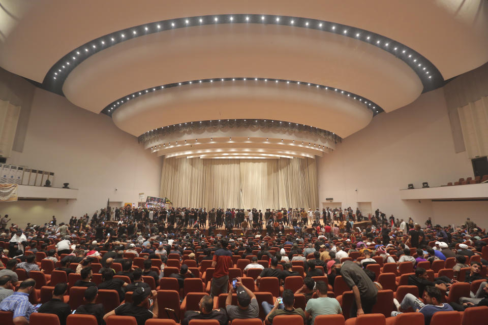 Iraqi protesters fill the parliament building in Baghdad, Iraq, Monday, Aug. 1, 2022. The political rivals of an influential Iraqi cleric whose followers stormed the parliament have declared their own counter-protest. The announcement on Monday stirred fear among Iraqis and caused security forces to erect concrete barriers leading to the heavily fortified Green Zone, home of the parliament building. (AP Photo/Anmar Khalil)