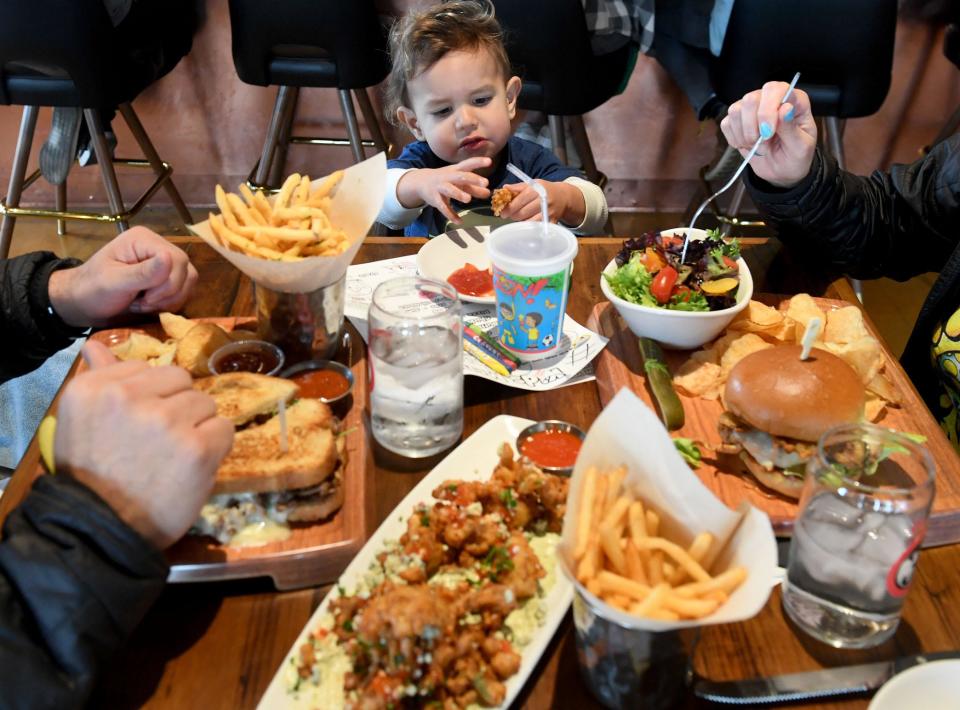 Christian Barragan, 18 months, enjoys eating with his parents Vanessa and Jose Barragan at the new Finney's Crafthouse in Camarillo on Thursday.