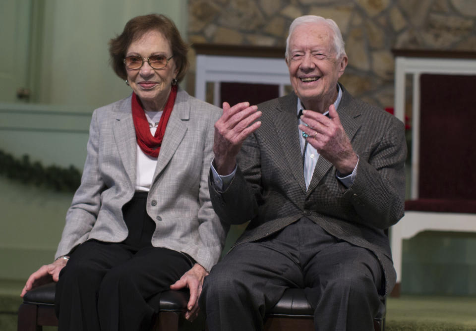 File-This Dec. 13, 2015, file photo shows former President Jimmy Carter, right, sitting with his wife, Rosalynn, as they wait to pose for photos with guests at Maranatha Baptist Church, in Plains, Ga. Carter said Monday, Feb. 19, 2018, he was "deathly afraid" as his 90-year-old wife underwent surgery over the weekend. Rosalynn Carter was recovering at Emory University Hospital in Atlanta after surgeons removed scar tissue from a portion of her small intestine early Sunday. Meanwhile, her husband of 71 years kept his scheduled appearance Monday at a President's Day even at the Jimmy Carter National Historic Site in his hometown of Plains. (AP Photo/Branden Camp, File)