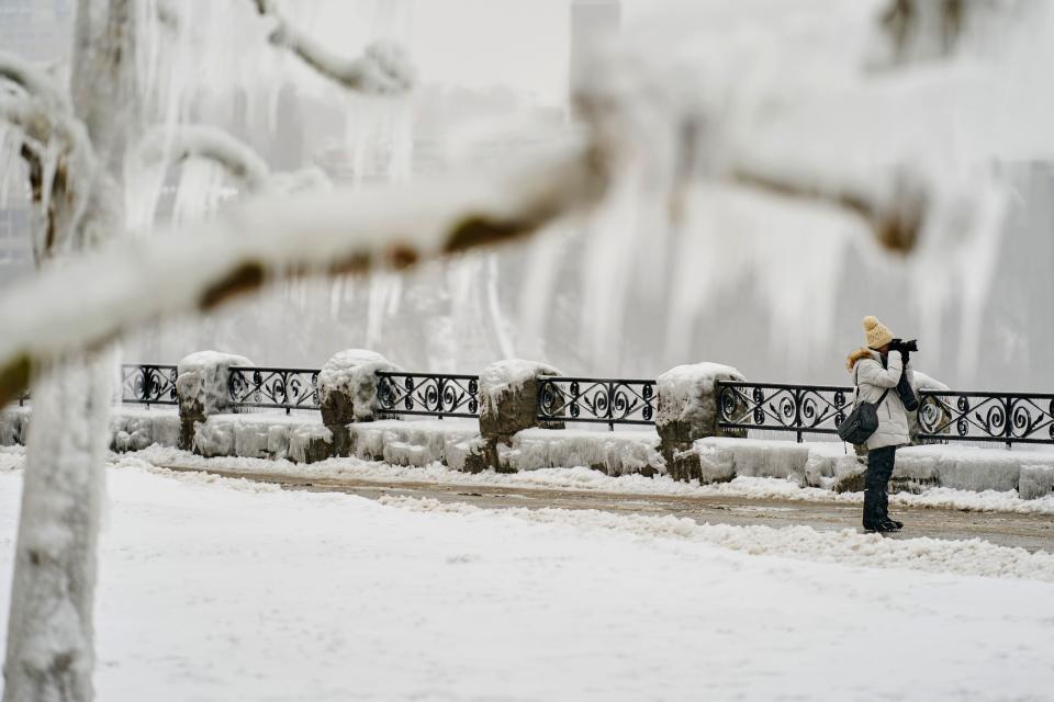 A photographer takes a photo at the Horseshoe Falls in Niagara Falls, Ontario, on January 27, 2021. (Photo by Geoff Robins / AFP) (Photo by GEOFF ROBINS/AFP via Getty Images)