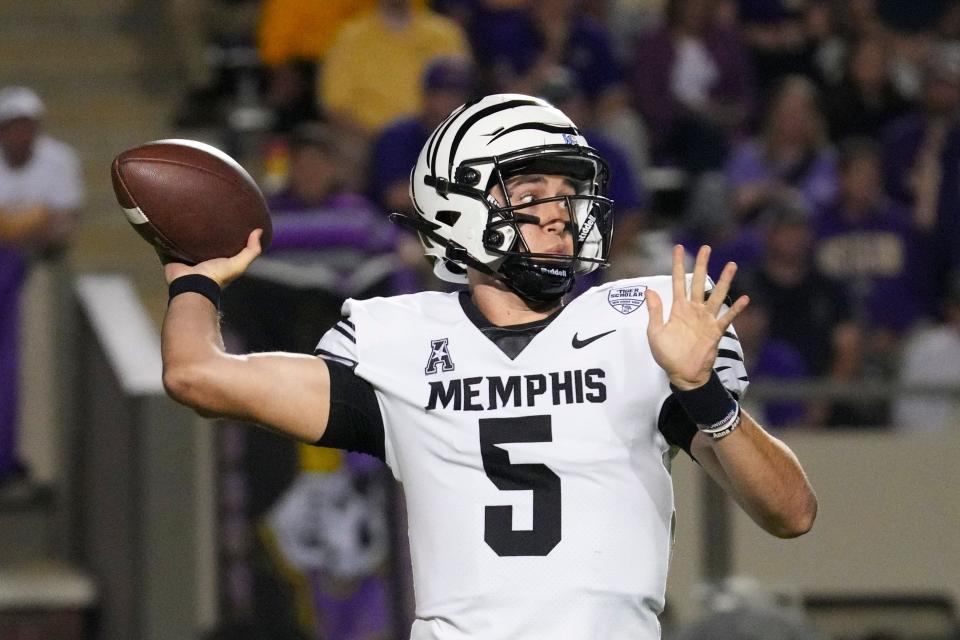 Oct 15, 2022; Greenville, North Carolina, USA; Memphis Tigers quarterback Seth Henigan (5) throws the ball against the East Carolina Pirates during the first half at Dowdy-Ficklen Stadium. Mandatory Credit: James Guillory-USA TODAY Sports