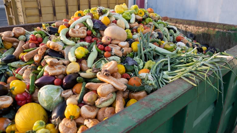 produce stacked in dumpster 