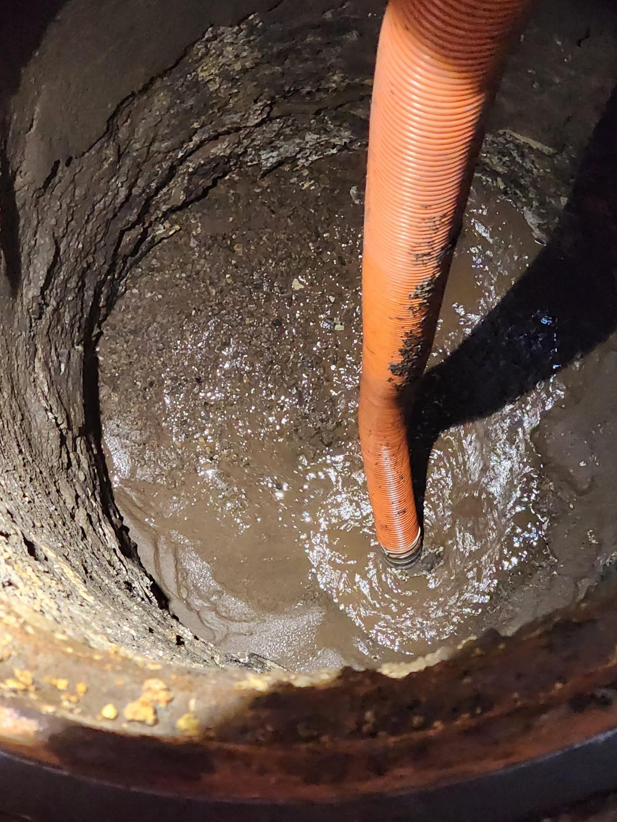 In an undated photo, Fillmore workers tried to suck water out of a manhole near the intersection of Highway 126 and C Street in Fillmore that was damaged on March 15 from heavy rains.