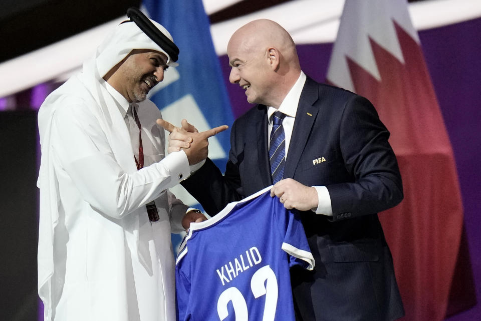 FILE - Prime Minister of the State of Qatar, Khalid Bin Khalifa Bin Abdulaziz Al Thani, left, receives a gift from FIFA President Gianni Infantino during the FIFA congress at the Doha Exhibition and Convention Center in Doha, Qatar, Thursday, March 31, 2022.A recent outpouring of local anger to scenes of foreign artists and models reveling in Qatar underscored the tensions tearing at the conservative Muslim emirate(AP Photo/Hassan Ammar, File)