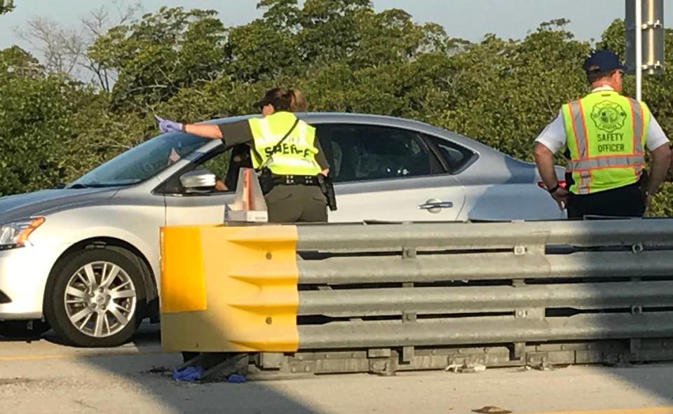 Monroe County Sheriff’s Office deputies and other law enforcement officers staff a checkpoint on the 18 Mile Stretch of U.S. 1 leading to the Florida Keys Friday, March 27, 2020.