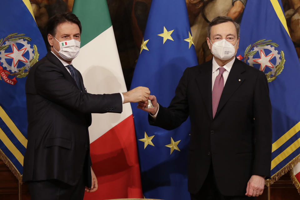 FILE - Italian outgoing Premier Giuseppe Conte hands over the cabinet minister bell to new Premier Mario Draghi, during the handover ceremony at Chigi Palace Premier's office, in Rome, Saturday, Feb. 13, 2021. A lawyer specializing in mediation, Conte, now 58, was plucked out of political obscurity to become premier in 2018 after the populist, euro-skeptic 5-Star Movement he now heads stunned Italy’s establishment by sweeping nearly 33% of the vote to become Parliament's largest party. As a premier Conte enforced one of the world’s strictest coronavirus lockdowns. Italy will elect a new Parliament on Sept. 25. (AP Photo/Andrew Medichini, File)