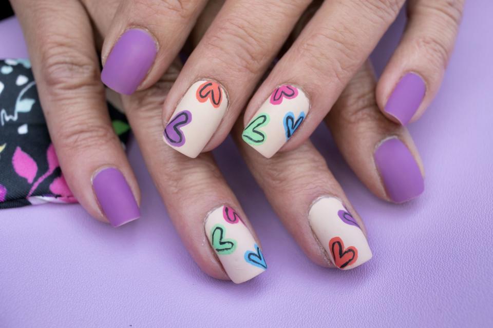 <p>Who says Valentine's Day is only about red and pink? This design pairs fun hearts with matte purple polish.</p>
