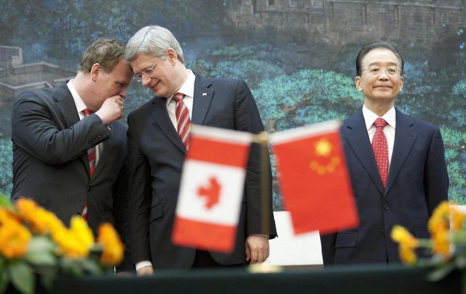 Stephen Harper speaks with John Baird while they stand next to Wen Jiabao, premier of the People’s Republic of China, in Beijing in February 2012. THE CANADIAN PRESS/Adrian Wyld