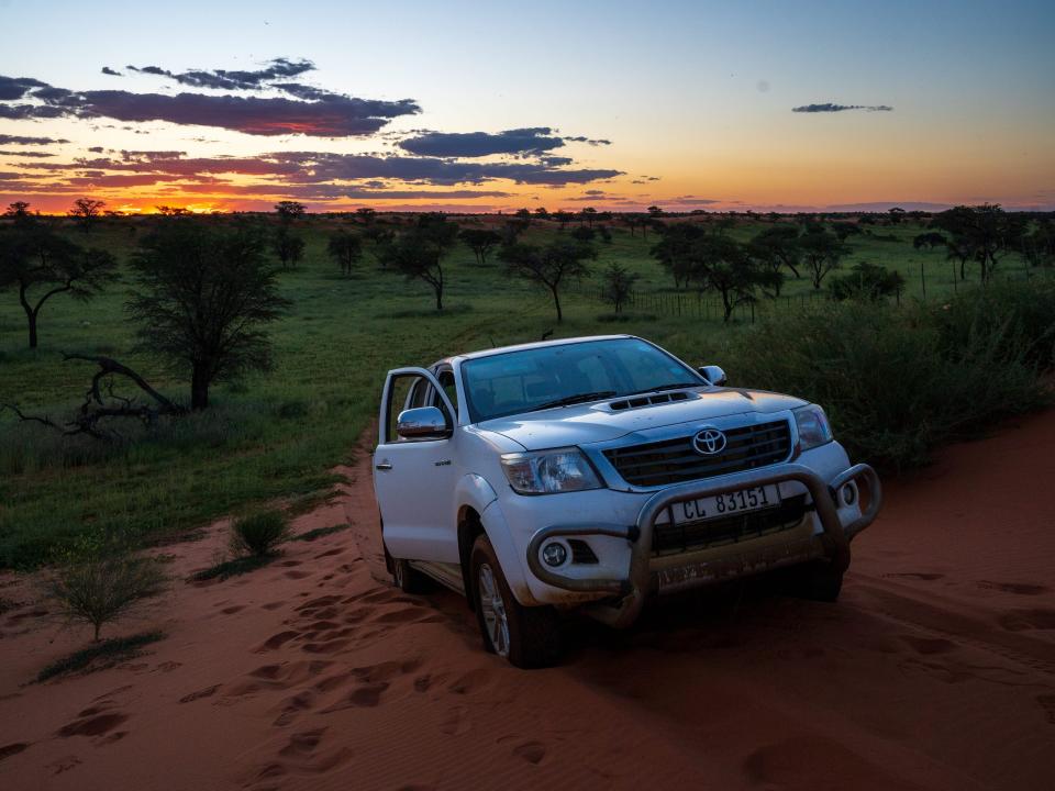 A car parked in front of the Savannah in Kalahari in Namibia.