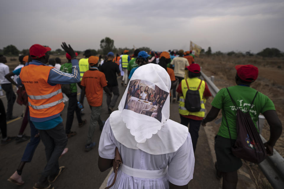 A sister wears headwear showing a picture of The Last Supper, as she and a group of the Catholic faithful from the town of Rumbek arrive after walking for more than a week to reach the capital for the visit of Pope Francis, in Juba, South Sudan Thursday, Feb. 2, 2023. Pope Francis is due to travel to South Sudan later this week on the second leg of a six-day trip that started in Congo, hoping to bring comfort and encouragement to two countries that have been riven by poverty, conflicts and what he calls a "colonialist mentality" that has exploited Africa for centuries. (AP Photo/Ben Curtis)
