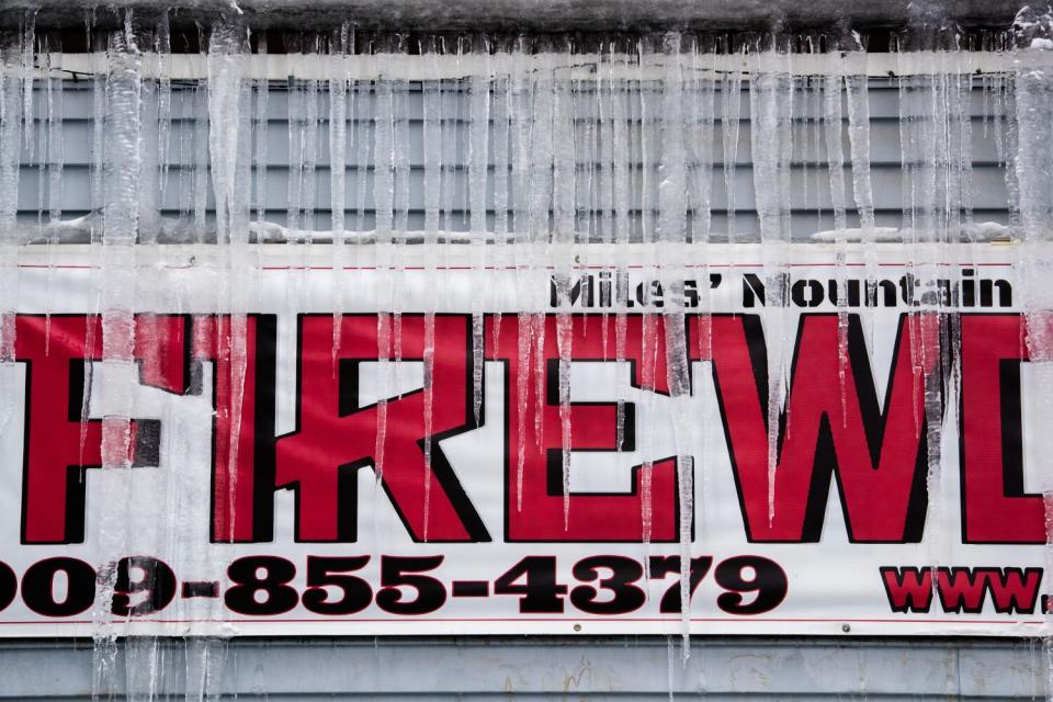 Icicles hang at a firewood lot as resort areas in the San Bernardino Mountains dig out from successive storms.