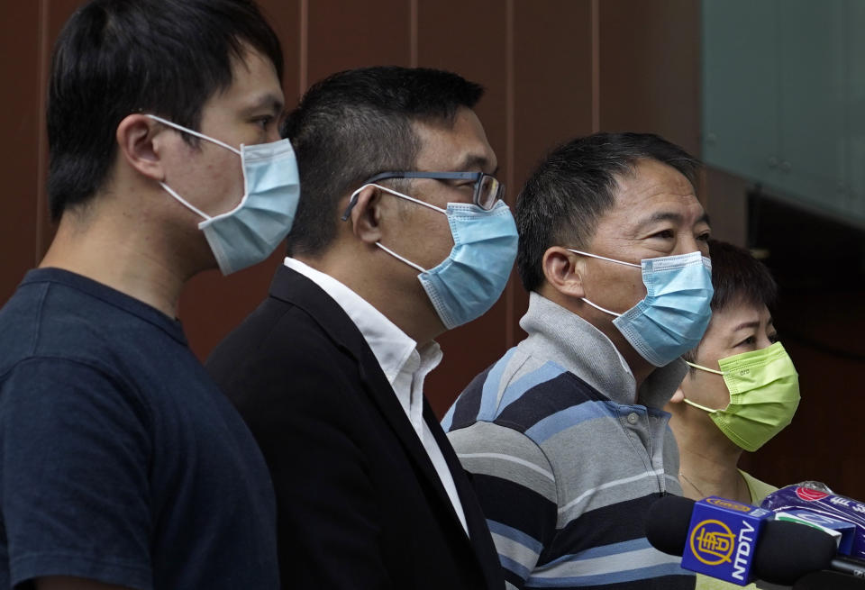 Chairman of Democratic Party, Wu Chi Wai, second from right, talks to reporters with other party members after pro-democracy legislators Ted Hui and Lam Cheuk-ting were arrested in Hong Kong Wednesday, Aug. 26, 2020. Hong Kong police arrested 16 people Wednesday on charges related to anti-government protests last year, including two opposition lawmakers. (AP Photo/Vincent Yu)