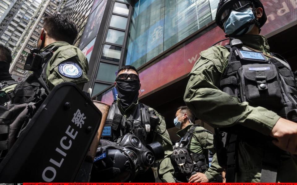 HONG KONG, CHINA - OCTOBER 01: Riot police officers stand alert during an attempt of illegal protest in Hong Kong, China, on October 1, 2020. Police deployed 6,000 officers during 71st China's National Day anniversary to counter any illegal protests and assemblies in Hong Kong. (Photo by Miguel Candela Poblacion/Anadolu Agency via Getty Images) - Anadolu Agency