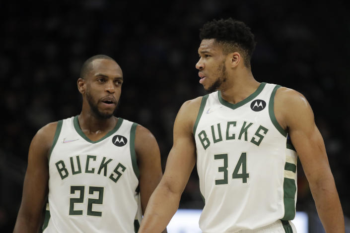 Milwaukee Bucks&#39; Giannis Antetokounmpo (34) talks with Khris Middleton (22) during the first half of an NBA basketball game against the Indiana Pacers Tuesday, Feb. 15, 2022, in Milwaukee. (AP Photo/Aaron Gash)