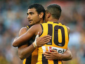 Cyril Rioli and Josh Hill celebrate another Hawks goal in their big win.