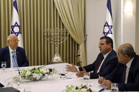 Memebers of the United List party sits next to Israeli President Reuven Rivlin as he began talks with political parties over who should form a new government, at his residence in Jerusalem