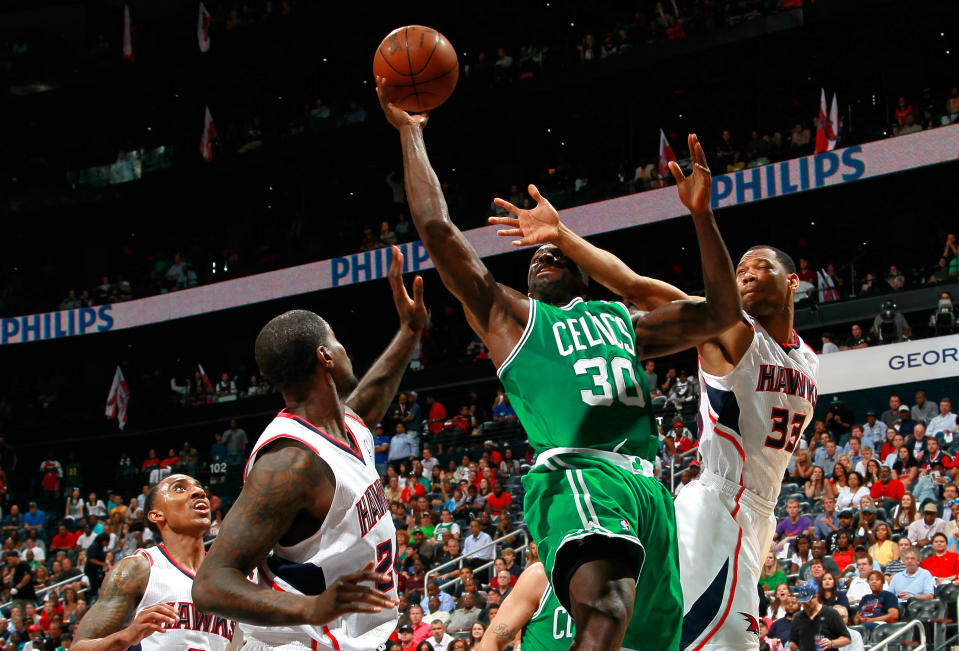 ATLANTA, GA - MAY 01: Willie Green #33 and Marvin Williams #24 of the Atlanta Hawks defends against Brandon Bass #30 of the Boston Celtics in Game Two of the Eastern Conference Quarterfinals in the 2012 NBA Playoffs at Philips Arena on May 1, 2012 in Atlanta, Georgia. NOTE TO USER: User expressly acknowledges and agrees that, by downloading and or using this photograph, User is consenting to the terms and conditions of the Getty Images License Agreement. (Photo by Kevin C. Cox/Getty Images)