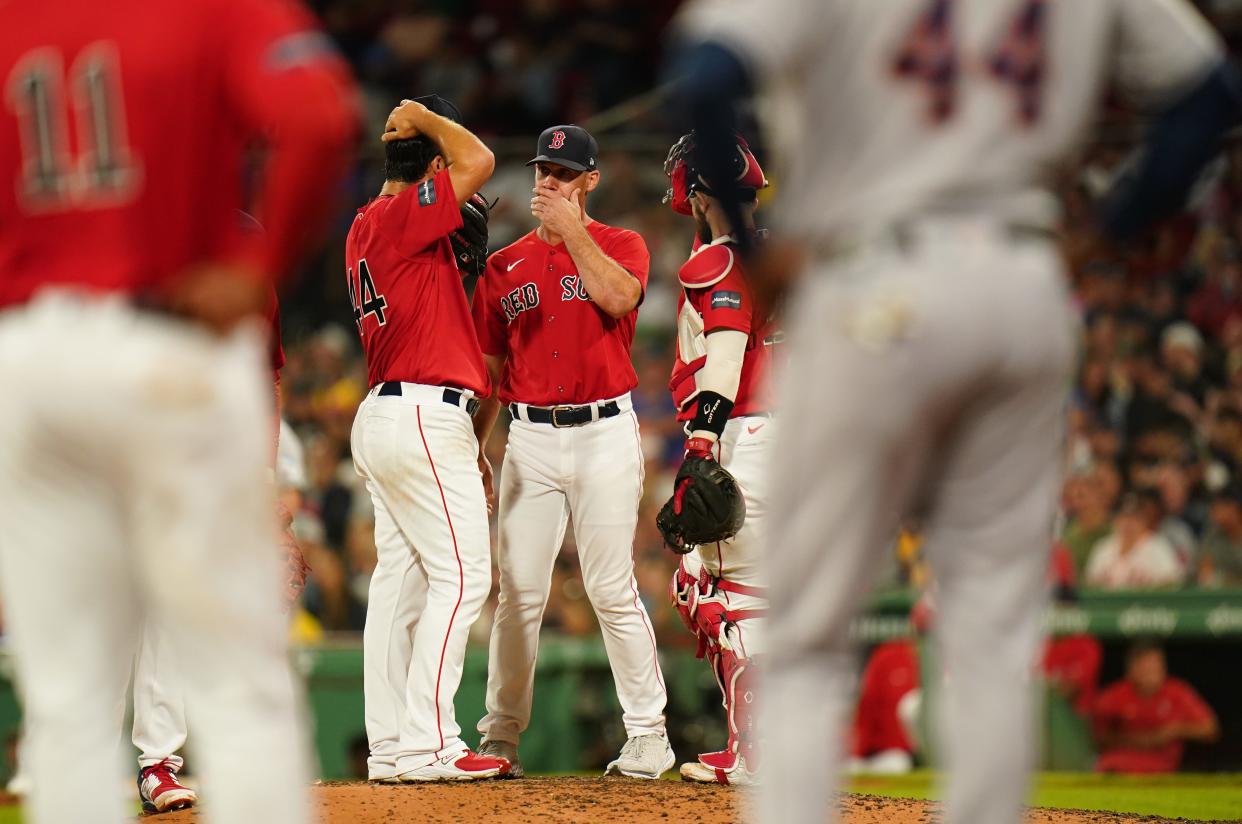 Red Sox pitching coach Dave Bush, second from left, talks with relief pitcher Kyle Barraclough in the seventh inning during Monday's game against the Houston Astros.