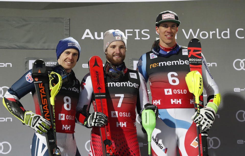 Marco Schwarz of Austria, center, winner of an alpine ski, men's World Cup parallel slalom, poses on the podium with second placed Britain's Dave Ryding left, and third placed Switzerland's Ramon Zenhaeusern, at Holmenkollen in Oslo, Norway, Tuesday, Jan. 1, 2019. (Terje Bendiksby/NTB scanpix via AP)