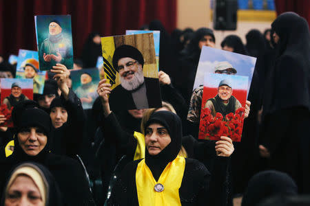 Female supporters of Lebanon's Hezbollah hold pictures of Lebanon's Hezbollah leader Sayyed Hassan Nasrallah and Hezbollah commander Mustafa Badreddine, who was killed in an attack in Syria, as Lebanon's Hezbollah leader Sayyed Hassan Nasrallah addresses his supporters in Beirut, Lebanon May 14, 2018. REUTERS/Aziz Taher