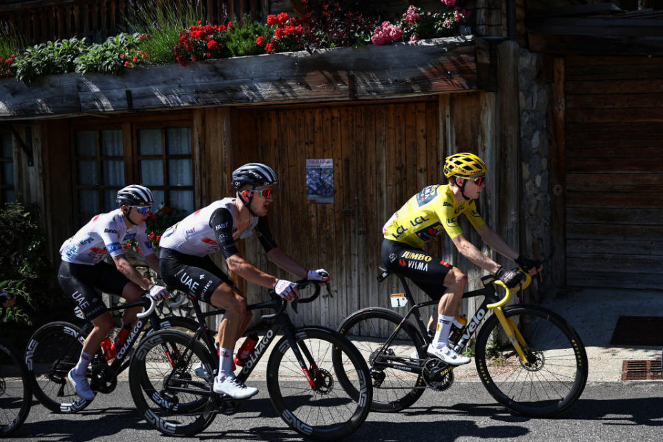 Jumbo-Visma's Danish rider Jonas Vingegaard wearing the overall leader's yellow jersey (R)  cycles ahead of Jumbo-Visma's Belgian rider Tiesj Benoot (C) and UAE Team Emirates' Slovenian rider Tadej Pogacar wearing the best young rider's white jersey (L) in the French Alps during the 15th stage of the 110th edition of the Tour de France cycling race, 179 km between Les Gets Les Portes du Soleil and Saint-Gervais Mont-Blanc, in eastern France, on July 16, 2023. (Photo by Anne-Christine POUJOULAT / AFP)