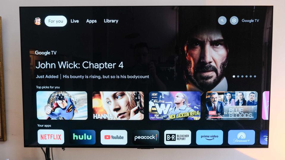 A TV shows a John Wick promotion on the Google TV home screen coming from the onn 4K Google TV streaming box