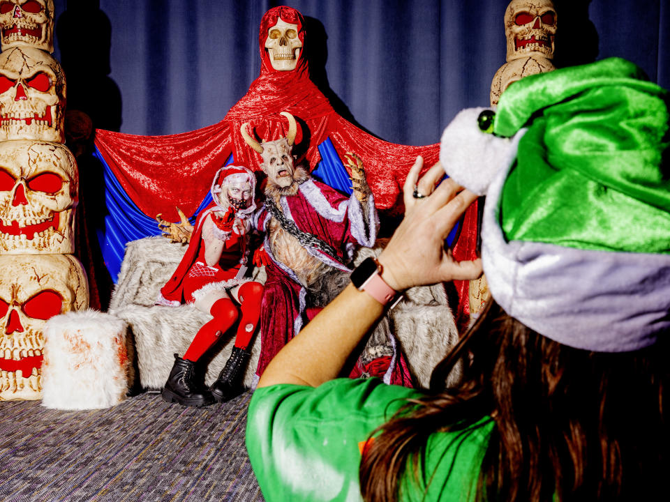 Aubrey Monserrate gets their photo with Krampus at "A Christmas to Dismember." 