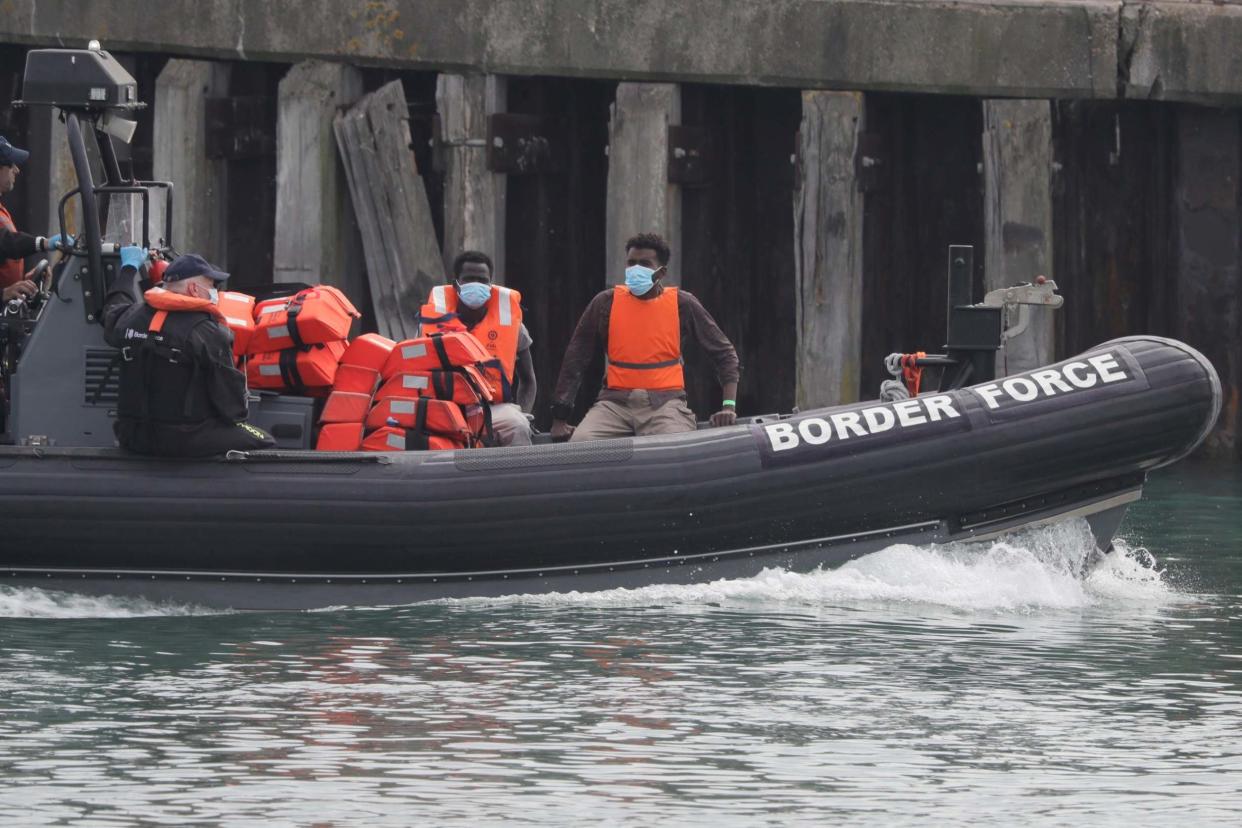 A Border Force vessel brings a group of people thought to be migrants into the port city of Dover: AP