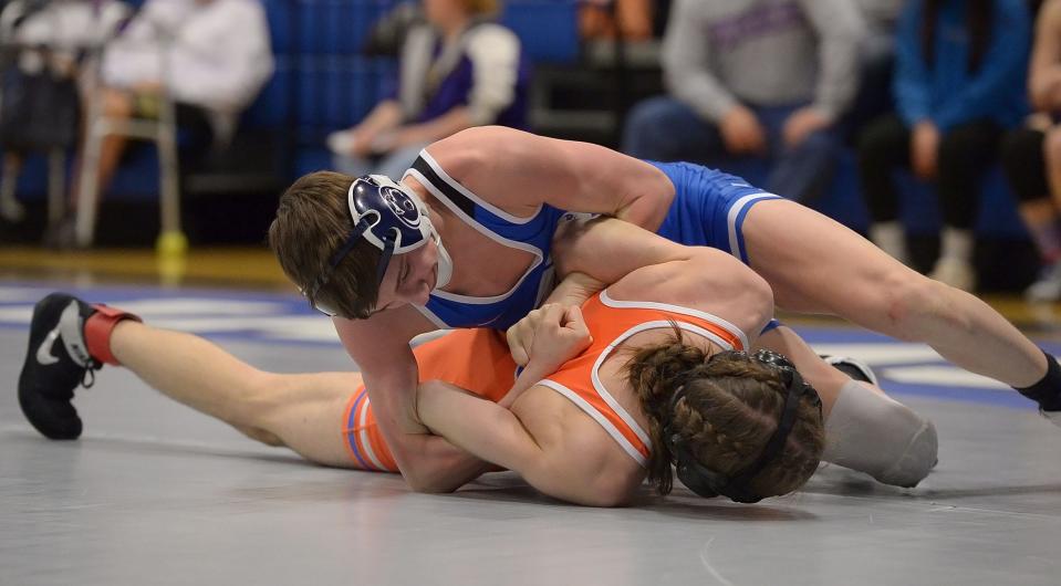 Williamsport's Camden Hull, top, locks up Boonsboro's Sean Martucci during the 113-pound title bout at the county tournament. Hull won by fall in the first period.