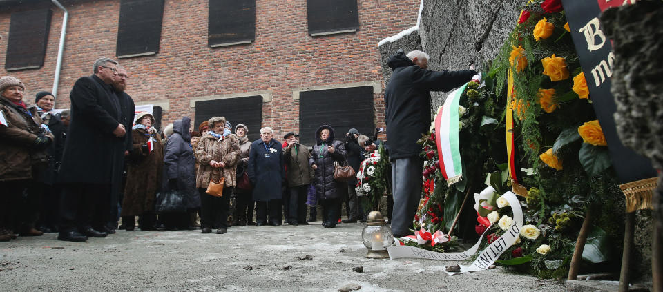 Polish President Bronislaw Komorowski (L) looks on as members of an association of Auschwitz concentration camp survivors arrive to lay wreaths at the execution wall at the former Auschwitz I concentration camp on January 27, 2015 in Oswiecim, Poland. International heads of state, dignitaries and over 300 Auschwitz survivors are attending the commemorations for the 70th anniversary of the liberation of Auschwitz by Soviet troops on 27th January, 1945. Auschwitz was among the most notorious of the concentration camps run by the Nazis during WWII and whilst it is impossible to put an exact figure on the death toll it is alleged that over a million people lost their lives in the camp, the majority of whom were Jewish. 