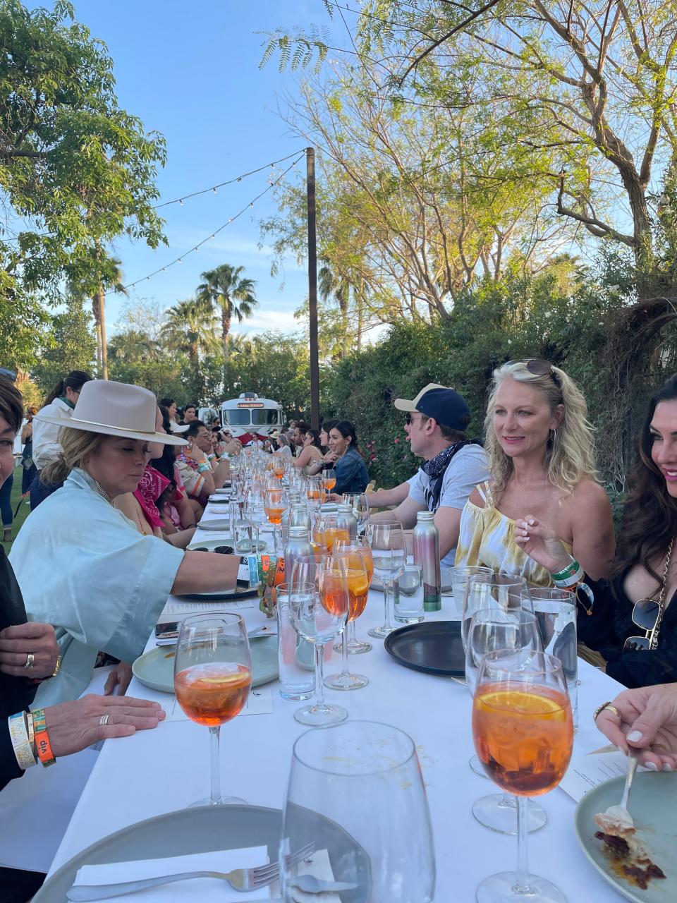 Festivalgoers chat while they eat and drink at Outstanding in the Field Sunday at the Coachella Valley Music and Arts Festival.