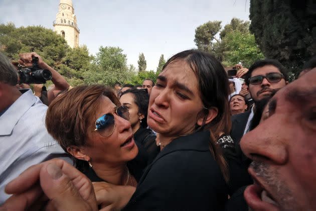 Mourners react during the burial of slain veteran Al-Jazeera journalist Shireen Abu Akleh at the Mount Zion Cemetery outside Jerusalem's Old City on May 13, two days after she was killed while covering an Israeli army raid in the West Bank. (Photo: HAZEM BADER via Getty Images)
